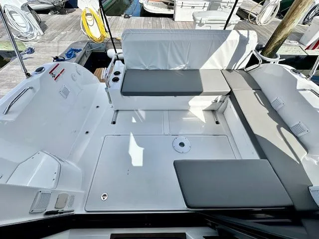 Slide: The Image of 2024 Beneteau Antares 9 boat deck with cushioned seating and dock view. - 7