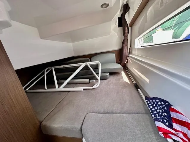 Slide: The Image of Interior cabin of 2024 Beneteau Antares 9 with seating and American flag. - 8