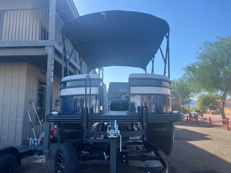 Slide: The Image of 2025 Lowe SS210DHCL pontoon boat on trailer, parked outdoors under clear sky. - 4