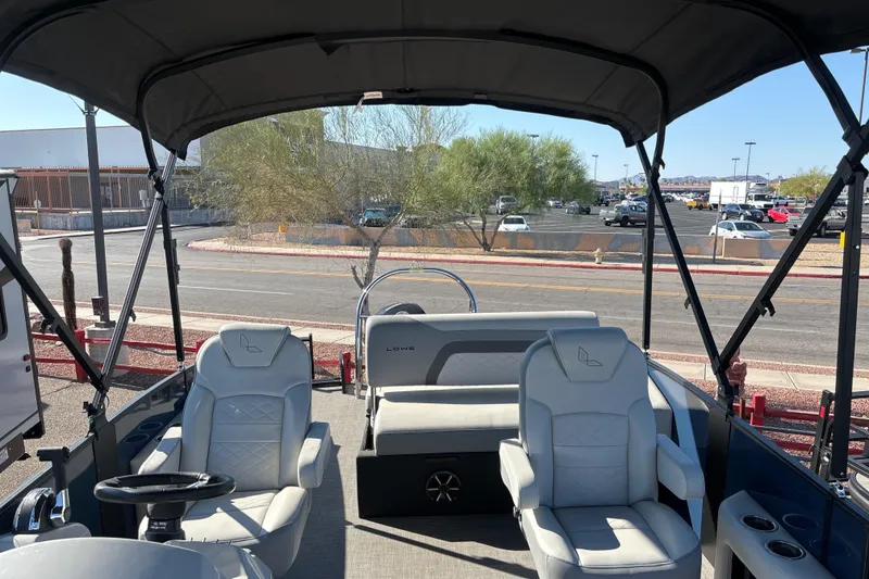Slide: The Image of 2025 Lowe SS210DHCL pontoon boat interior with seating and canopy. - 7