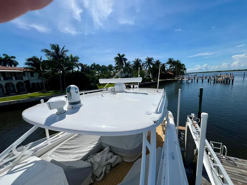 Slide: The Image of 2018 Intrepid 407 Cuddy boat docked by a scenic waterfront. - 16