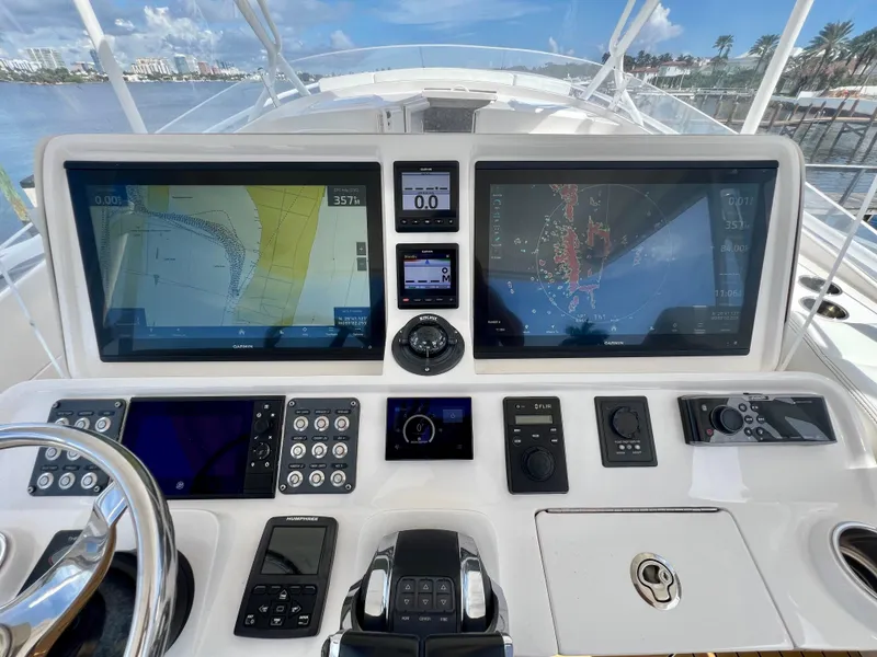 Slide: The Image of 2018 Intrepid 407 Cuddy boat dashboard with navigation screens and controls. - 17