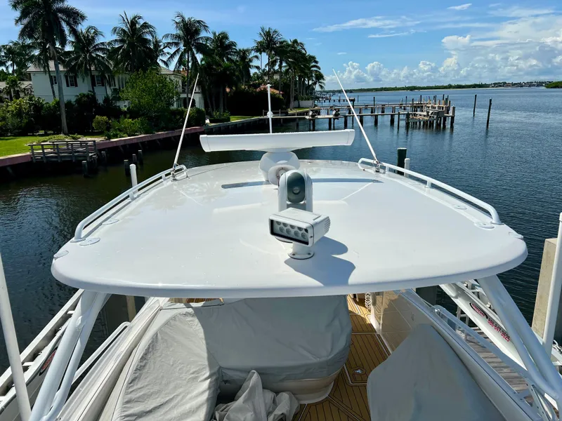 Slide: The Image of 2018 Intrepid 407 Cuddy boat docked by palm trees and waterfront. - 21
