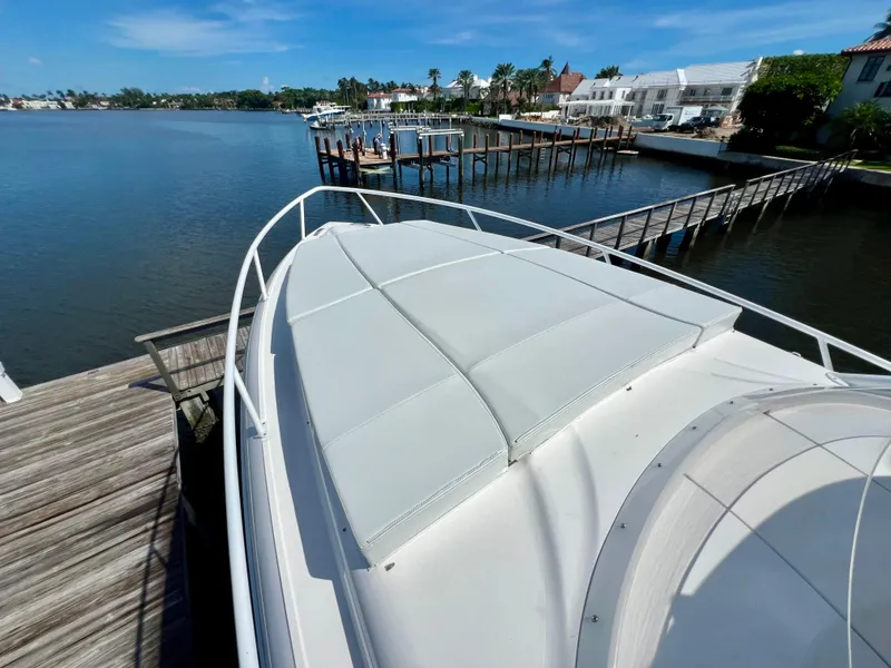 Slide: The Image of 2018 Intrepid 407 Cuddy boat docked by waterfront homes. - 22