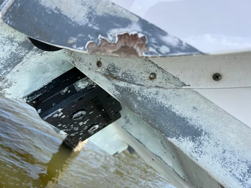 Slide: The Image of Close-up of 2018 Intrepid 407 Cuddy boat hull with visible wear and water exposure. - 25