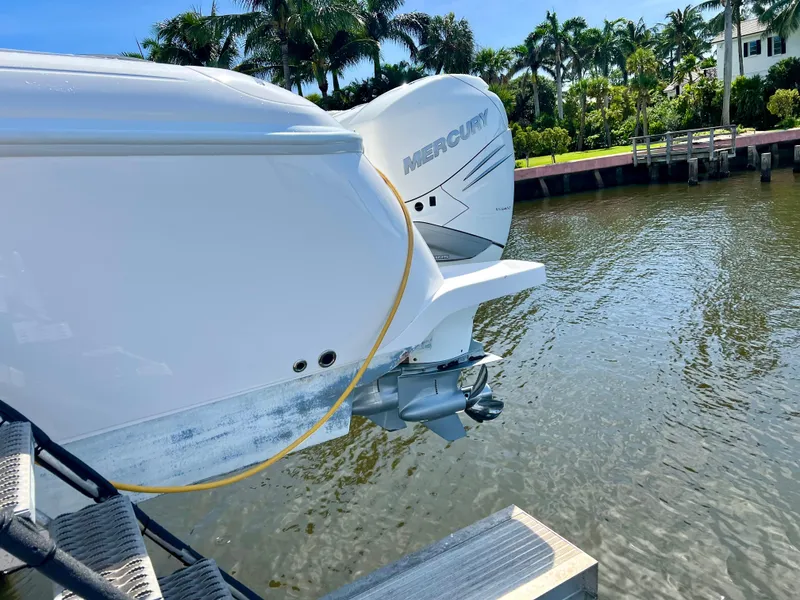 Slide: The Image of 2018 Intrepid 407 Cuddy boat with Mercury engine by a tropical waterfront. - 26