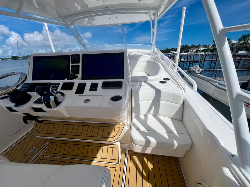 Slide: The Image of 2018 Intrepid 407 Cuddy boat interior with modern helm and seating. - 28