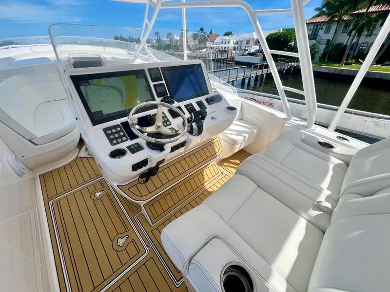 Slide: The Image of 2018 Intrepid 407 Cuddy boat cockpit with modern navigation system and luxurious seating. - 29