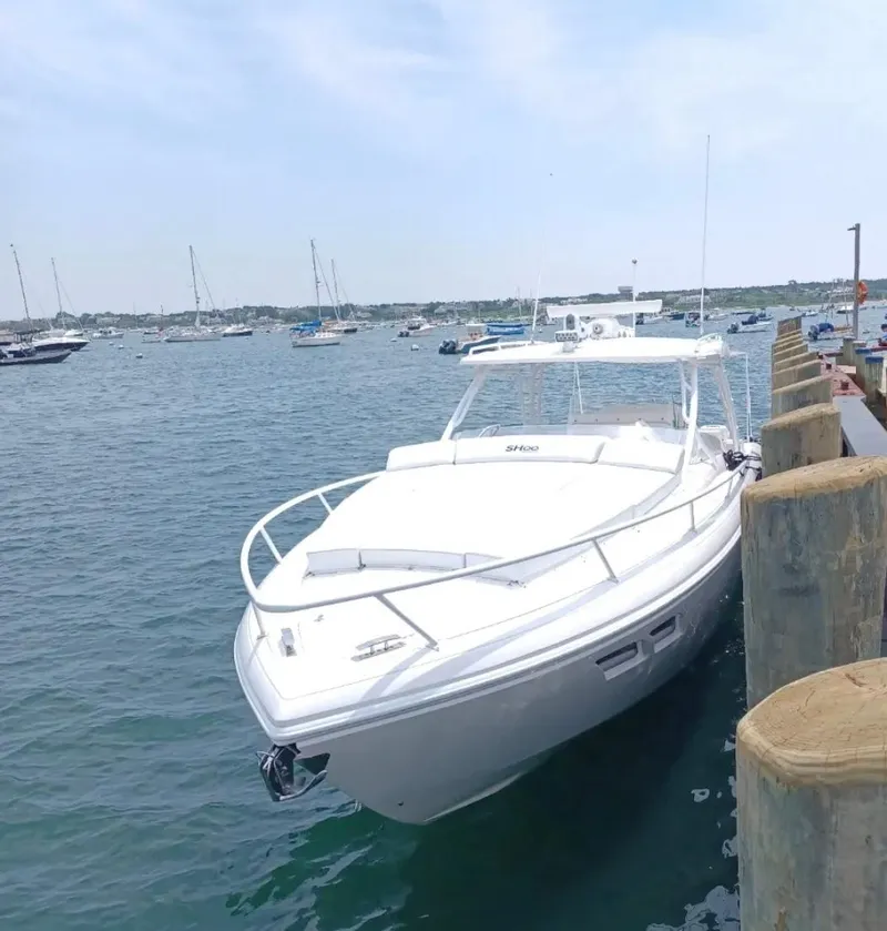 Slide: The Image of 2018 Intrepid 407 Cuddy boat docked by the pier on a sunny day. - 3