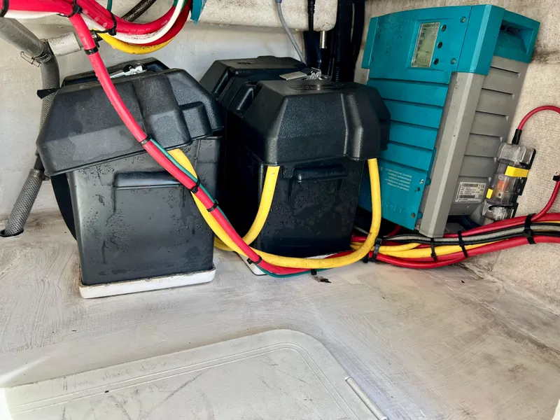 Slide: The Image of 2018 Intrepid 407 Cuddy boat battery compartment with wiring and electrical components. - 30
