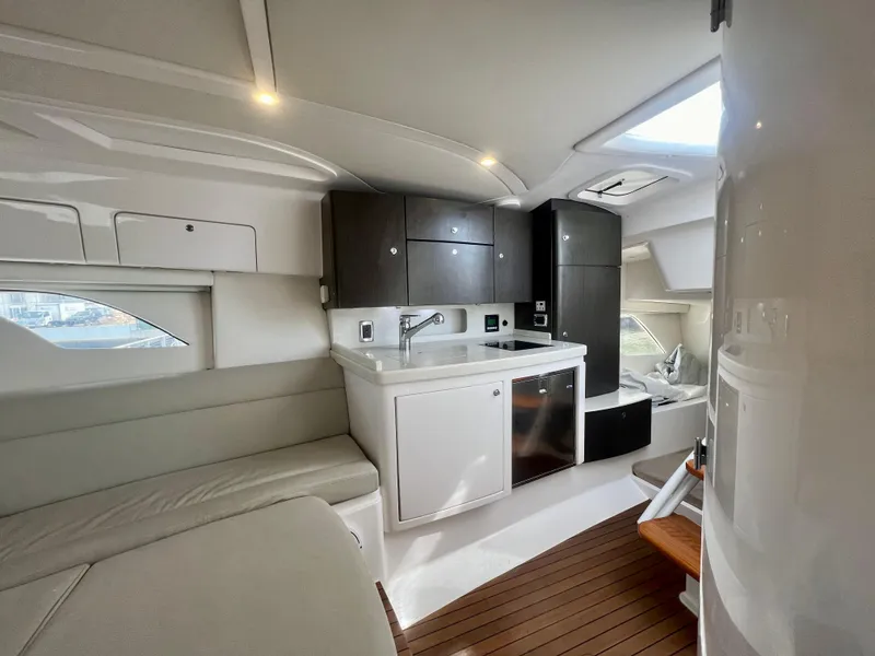 Slide: The Image of 2018 Intrepid 407 Cuddy interior with modern kitchen and seating area. - 33