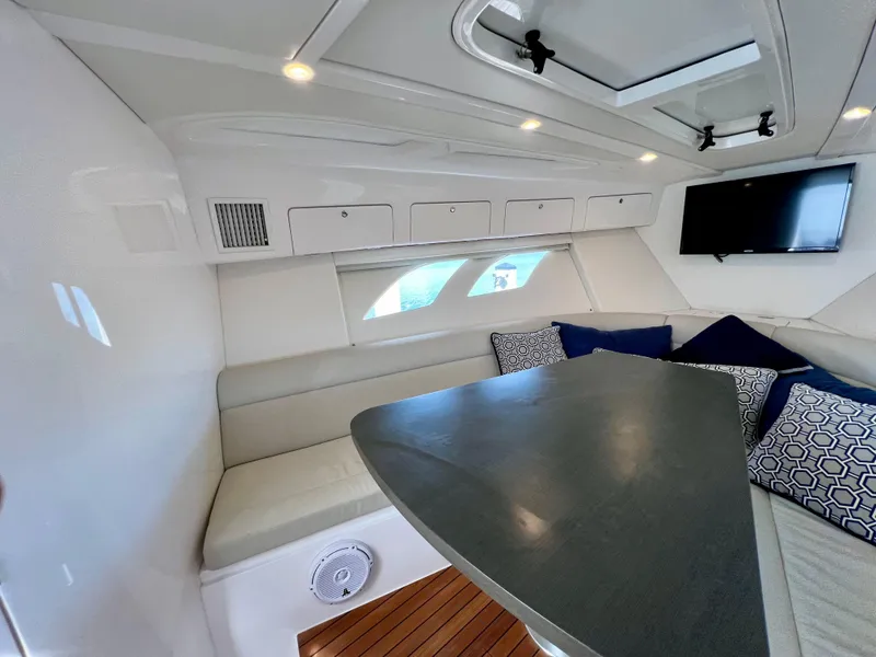 Slide: The Image of Luxurious interior of 2018 Intrepid 407 Cuddy with seating, table, and TV. - 36