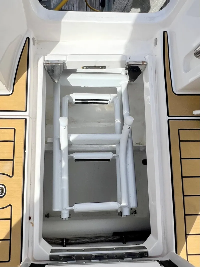 Slide: The Image of 2018 Intrepid 407 Cuddy boat hatch with ladder, featuring teak flooring. - 37