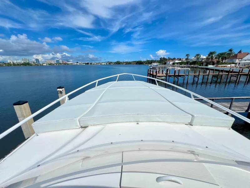 Slide: The Image of 2018 Intrepid 407 Cuddy boat docked with scenic waterfront view. - 38