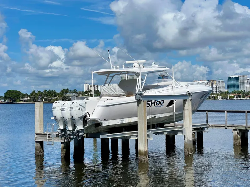 Slide: The Image of 2018 Intrepid 407 Cuddy boat on lift, scenic waterfront view. - 4