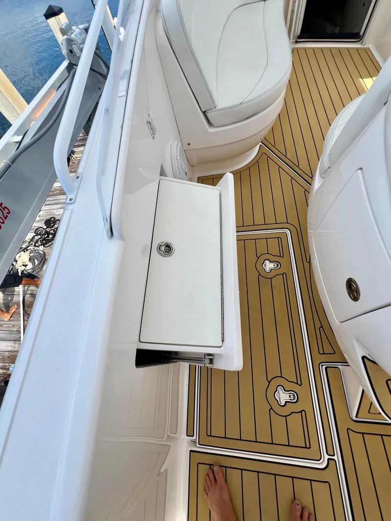 Slide: The Image of 2018 Intrepid 407 Cuddy boat interior with teak flooring and white seating. - 40