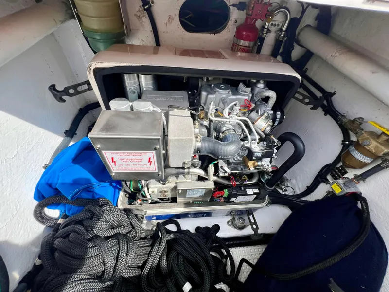 Slide: The Image of Engine compartment of a 2018 Intrepid 407 Cuddy boat with visible equipment and ropes. - 45