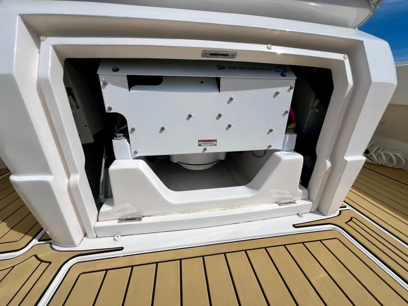 Slide: The Image of 2018 Intrepid 407 Cuddy boat storage compartment with teak flooring. - 48