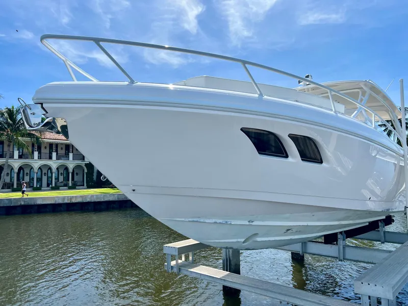 Slide: The Image of 2018 Intrepid 407 Cuddy boat on lift, dockside view. - 5
