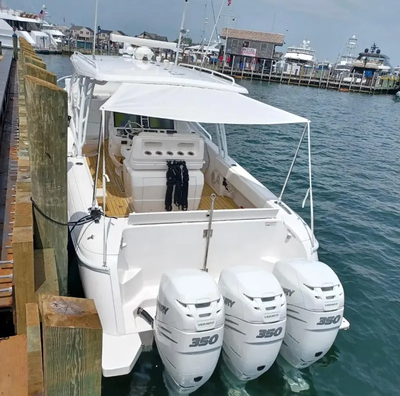 Slide: The Image of 2018 Intrepid 407 Cuddy boat docked with triple Mercury 350 engines. - 7