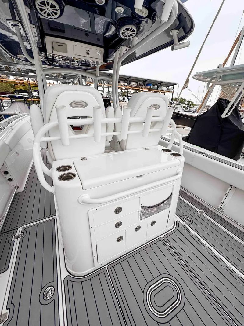 Slide: The Image of 2018 Sportsman Open 312 Center Console boat interior with seating and storage. - 10