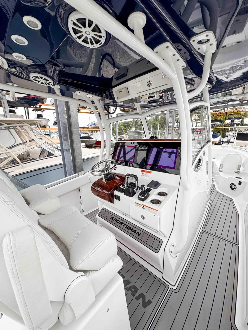 Slide: The Image of 2018 Sportsman Open 312 Center Console boat interior with modern controls and seating. - 14