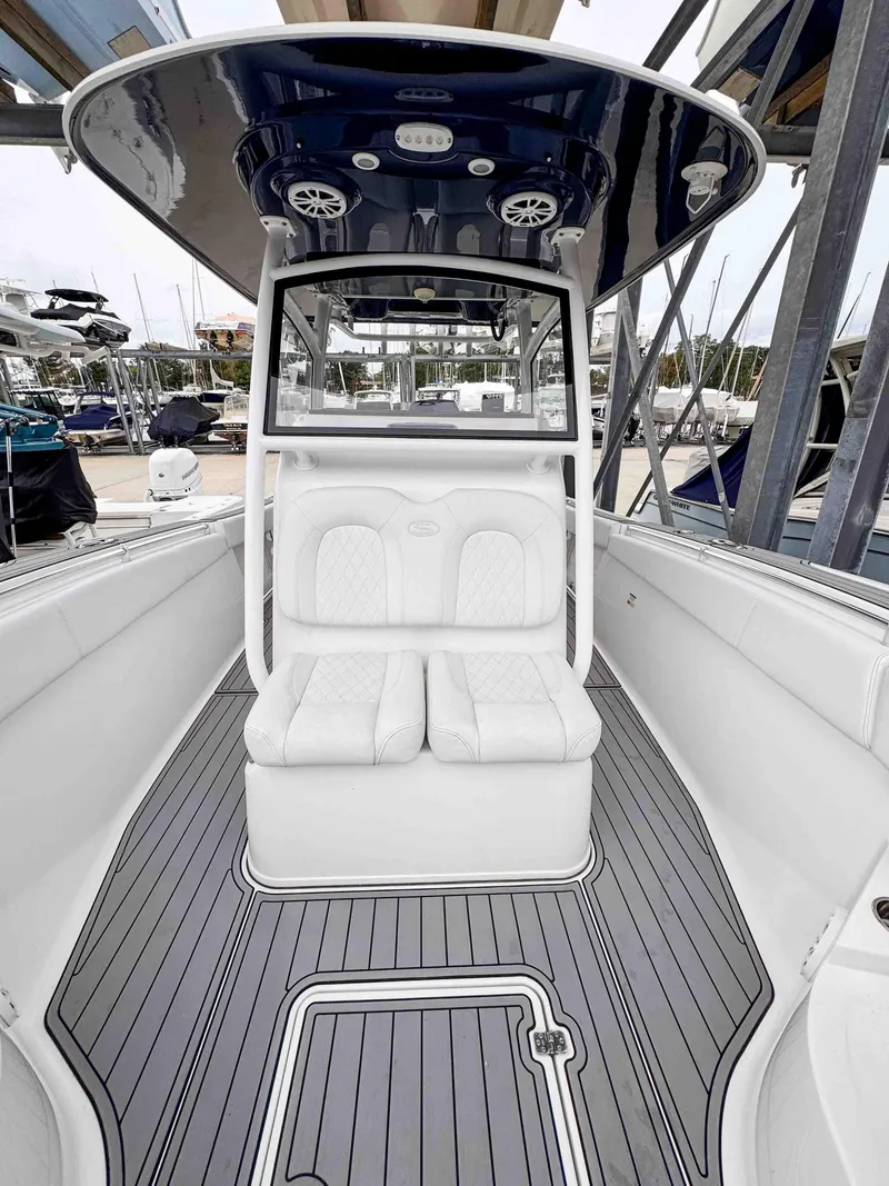 Slide: The Image of 2018 Sportsman Open 312 Center Console boat interior with sleek seating and modern design. - 17