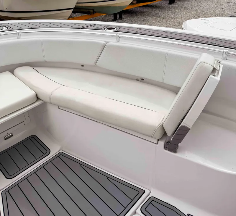 Slide: The Image of 2018 Sportsman Open 312 Center Console boat interior with cushioned seating and non-slip flooring. - 20