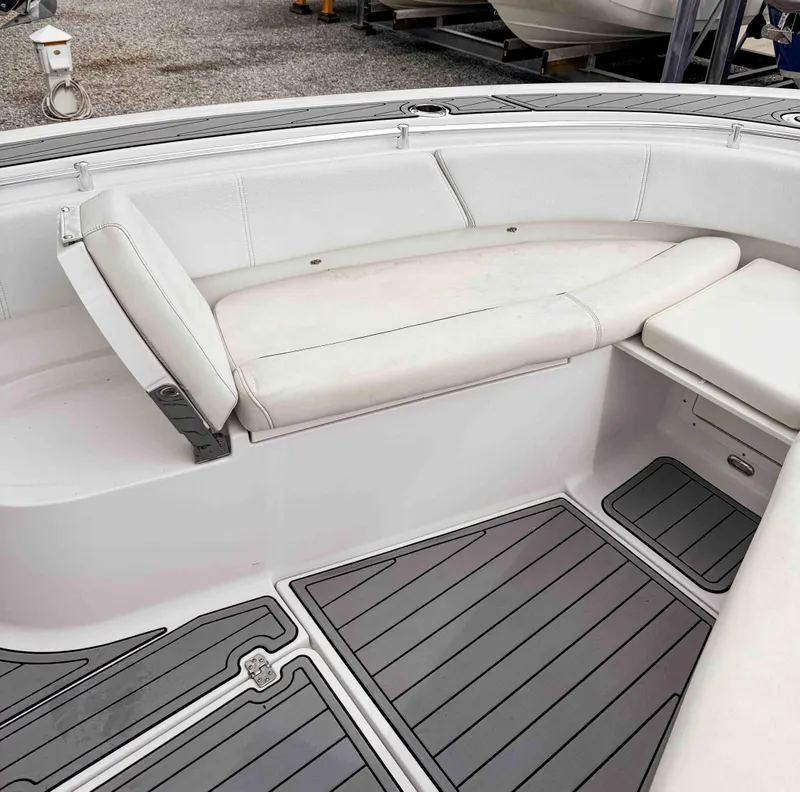 Slide: The Image of 2018 Sportsman Open 312 Center Console boat interior with white seating and gray flooring. - 21