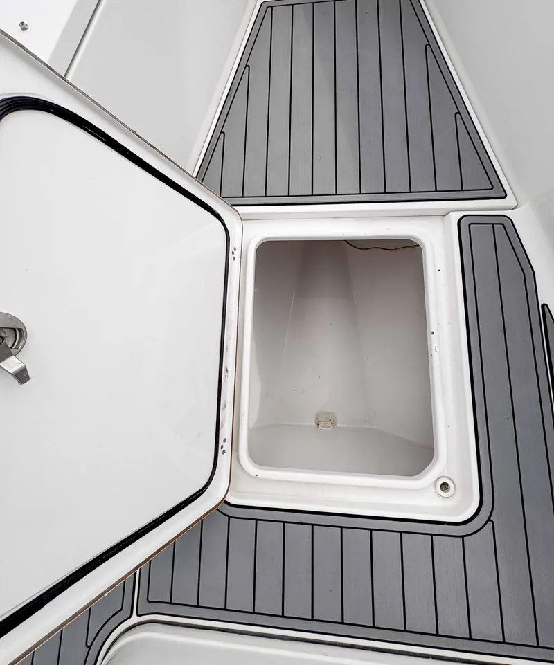 Slide: The Image of 2018 Sportsman Open 312 Center Console storage compartment with open hatch. - 26