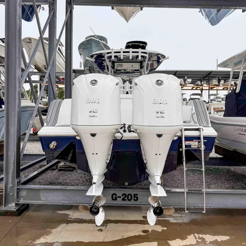 Slide: The Image of 2018 Sportsman Open 312 Center Console with twin outboard engines in storage. - 6