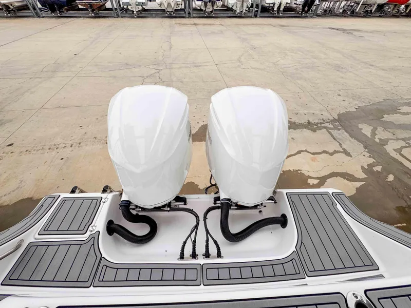 Slide: The Image of 2018 Sportsman Open 312 Center Console with dual outboard engines on a dock. - 7