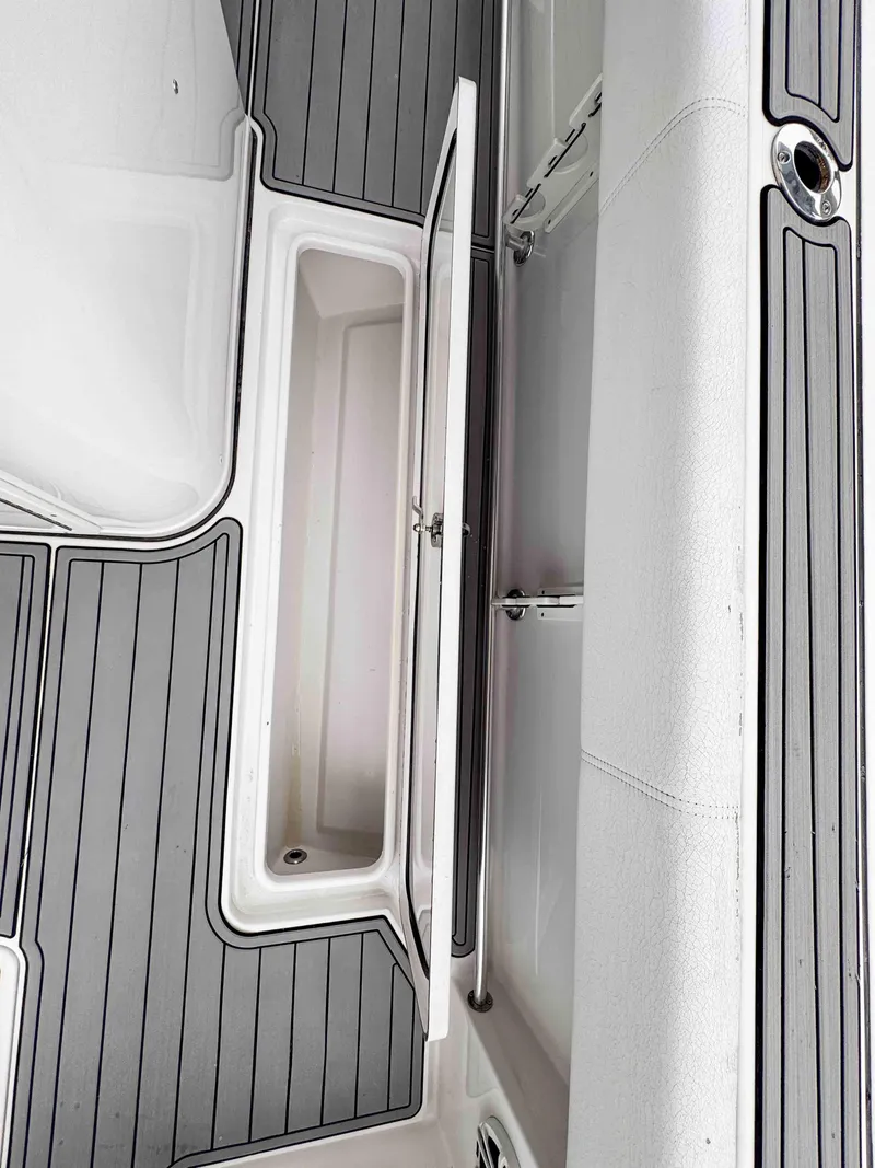 Slide: The Image of 2018 Sportsman Open 312 Center Console boat interior with storage compartment. - 9