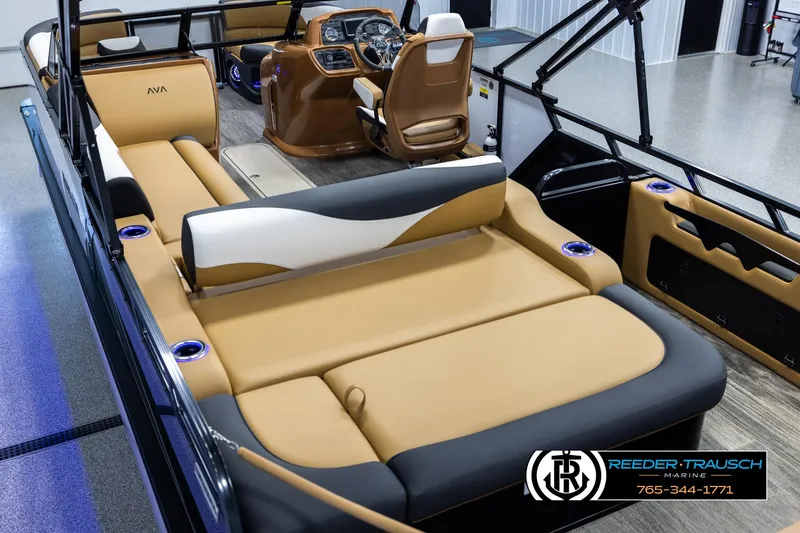 Slide: The Image of 2025 Avalon LSZ VRB boat interior with tan seating and modern dashboard. - 11