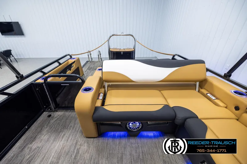 Slide: The Image of 2025 Avalon LSZ VRB boat interior with tan and black seating, blue LED lighting. - 15