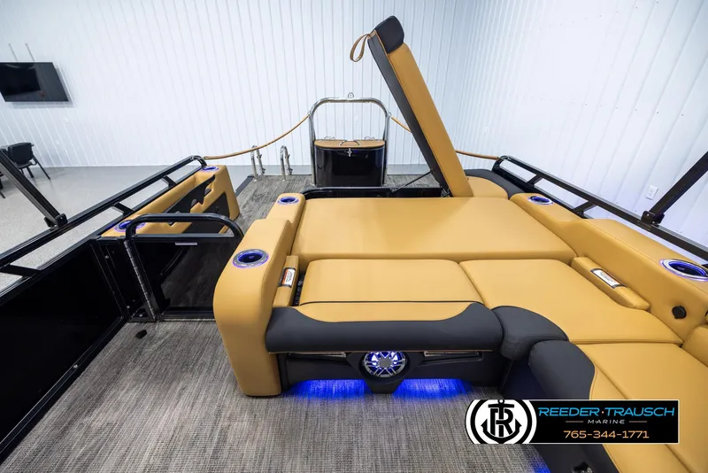 Slide: The Image of 2025 Avalon LSZ VRB boat interior with tan seating and blue LED lighting. - 18