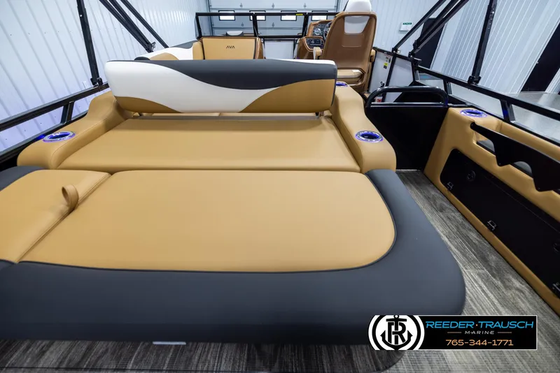 Slide: The Image of 2025 Avalon LSZ VRB boat interior with tan and black seating, cup holders, and steering console. - 19