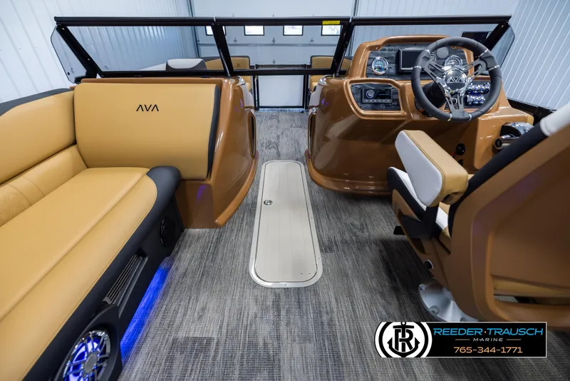 Slide: The Image of 2025 Avalon LSZ VRB boat interior with tan seating and modern dashboard. - 20
