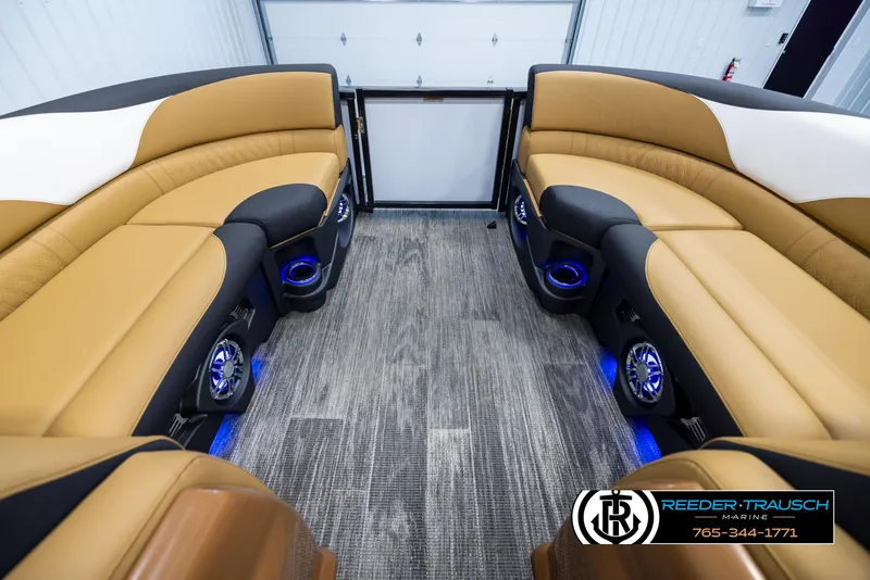 Slide: The Image of Luxurious 2025 Avalon LSZ VRB boat interior with tan seating and blue LED lighting. - 21