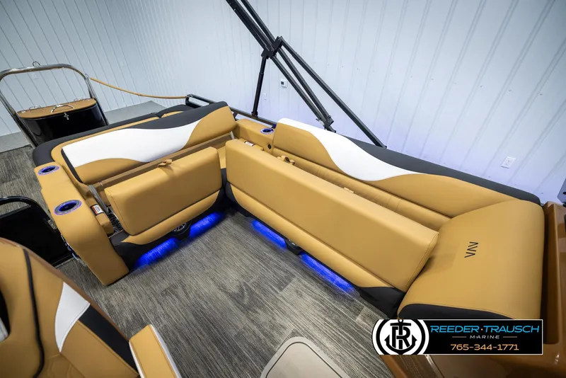 Slide: The Image of 2025 Avalon LSZ VRB boat interior with tan seating and blue LED lighting. - 25