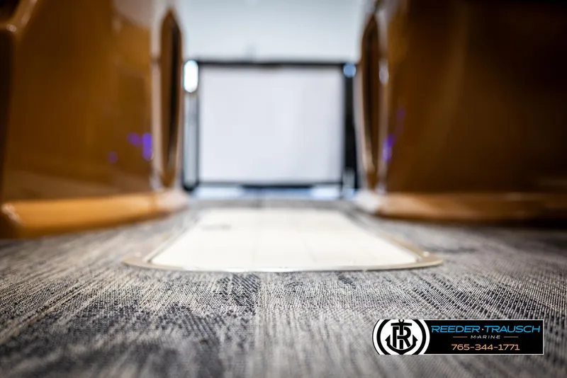 Slide: The Image of 2025 Avalon LSZ VRB interior with carpeted flooring, Reeder-Trausch Marine logo. - 44