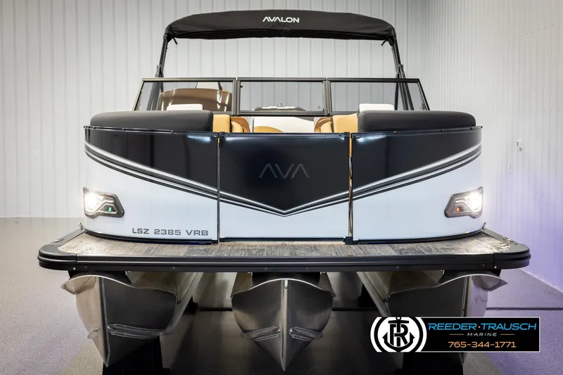 Slide: The Image of 2025 Avalon LSZ VRB pontoon boat, sleek design, black and white exterior, showroom display. - 8