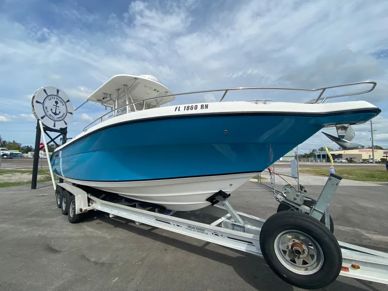 Slide: The Image of 2008 Century 2901 Center Console boat on trailer, blue hull, parked outdoors. - 20