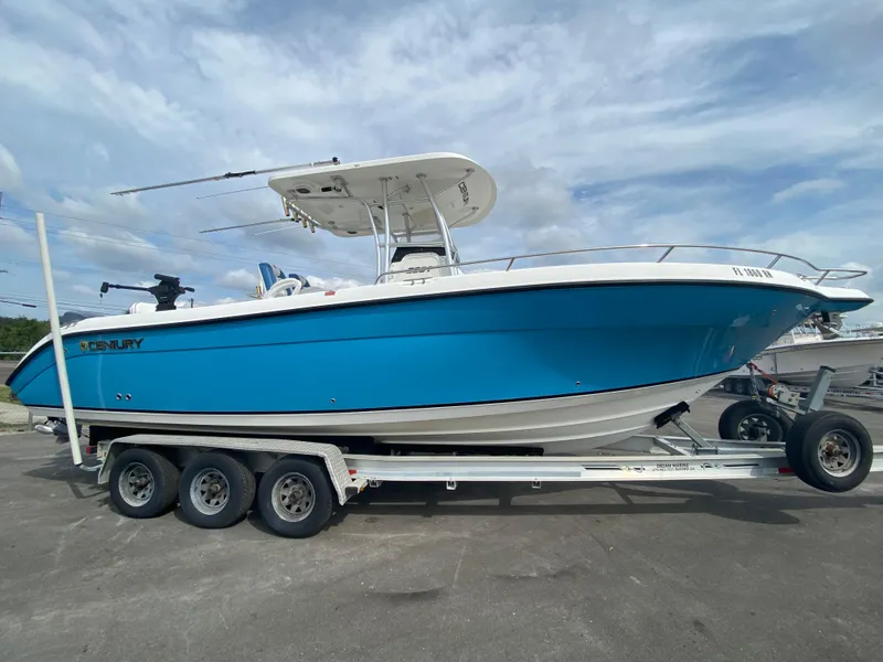 Slide: The Image of 2008 Century 2901 Center Console boat on a trailer, blue hull, parked outdoors. - 21