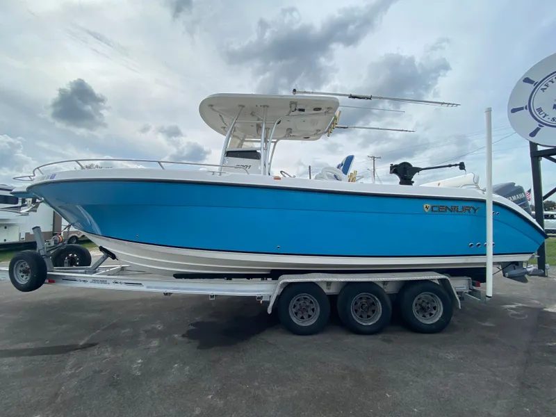 Slide: The Image of 2008 Century 2901 Center Console boat on a trailer, blue hull, overcast sky. - 29