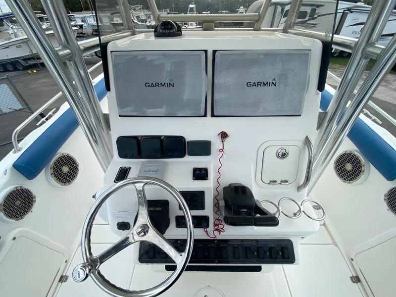 Slide: The Image of Century 2901 Center Console 2008 boat dashboard with Garmin navigation displays. - 37