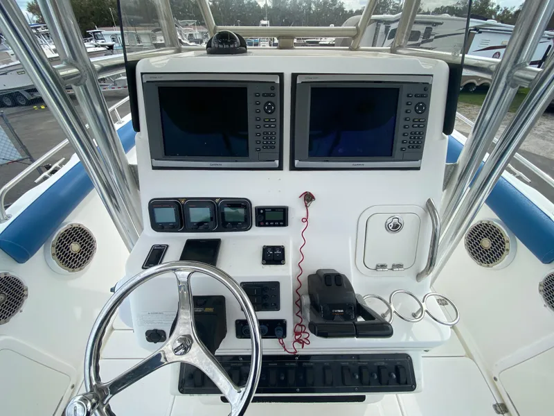 Slide: The Image of Century 2901 Center Console 2008 boat dashboard with dual screens and controls. - 38