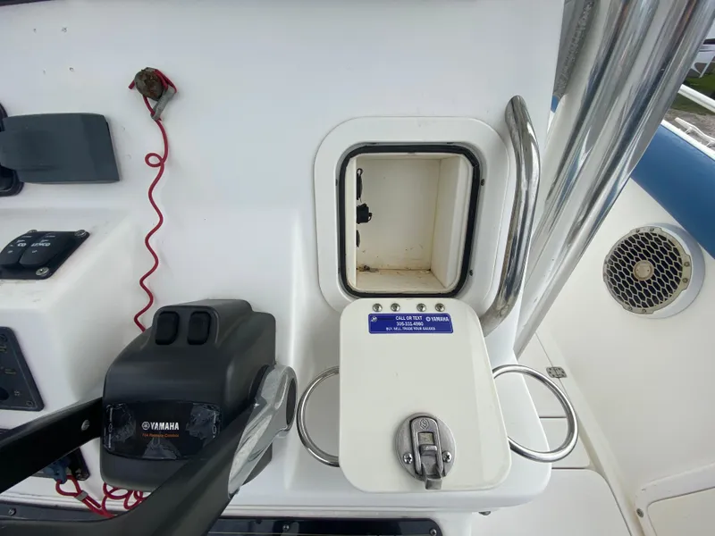 Slide: The Image of 2008 Century 2901 Center Console boat dashboard with Yamaha controls and storage compartment. - 46