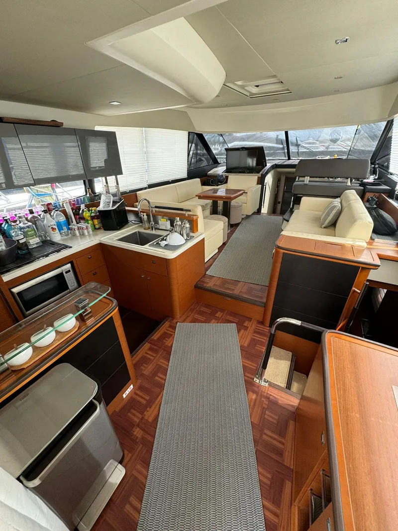 Slide: The Image of Luxurious 2014 Prestige 550 yacht interior with modern kitchen and seating area. - 15