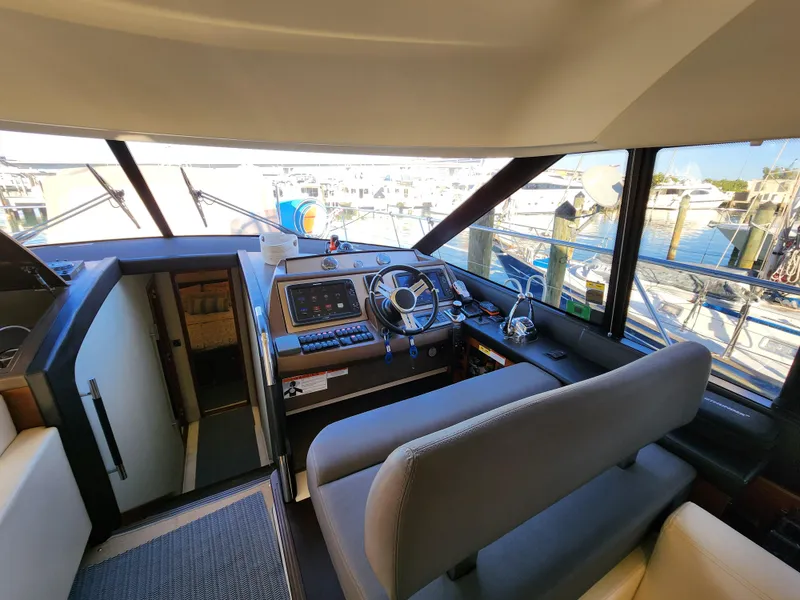 Slide: The Image of Interior view of 2014 Prestige 550 yacht cockpit with steering wheel and navigation controls. - 20